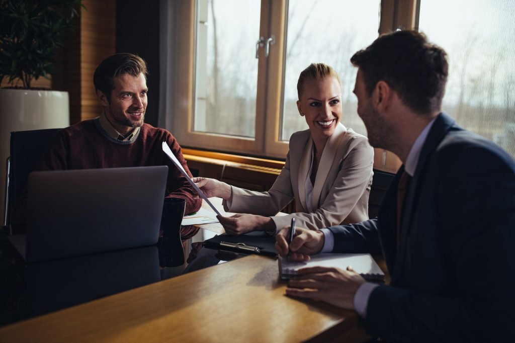 Advisor reviewing documents with clients during a meeting