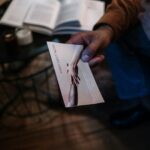 A person holds a help brochure in a cozy indoor setting, symbolizing support and mental health awareness.